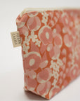 Floral patterned pouch with a visible brand tag on a white background