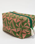Green and pink patterned toiletry bag with a green zipper on a white background