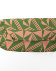 Green and pink geometric patterned pouch on a white background