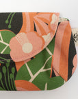 Floral patterned pouch with green leaves and orange flowers on a white background