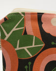 Fabric swatch with floral pattern and Megan Carter label on a white background