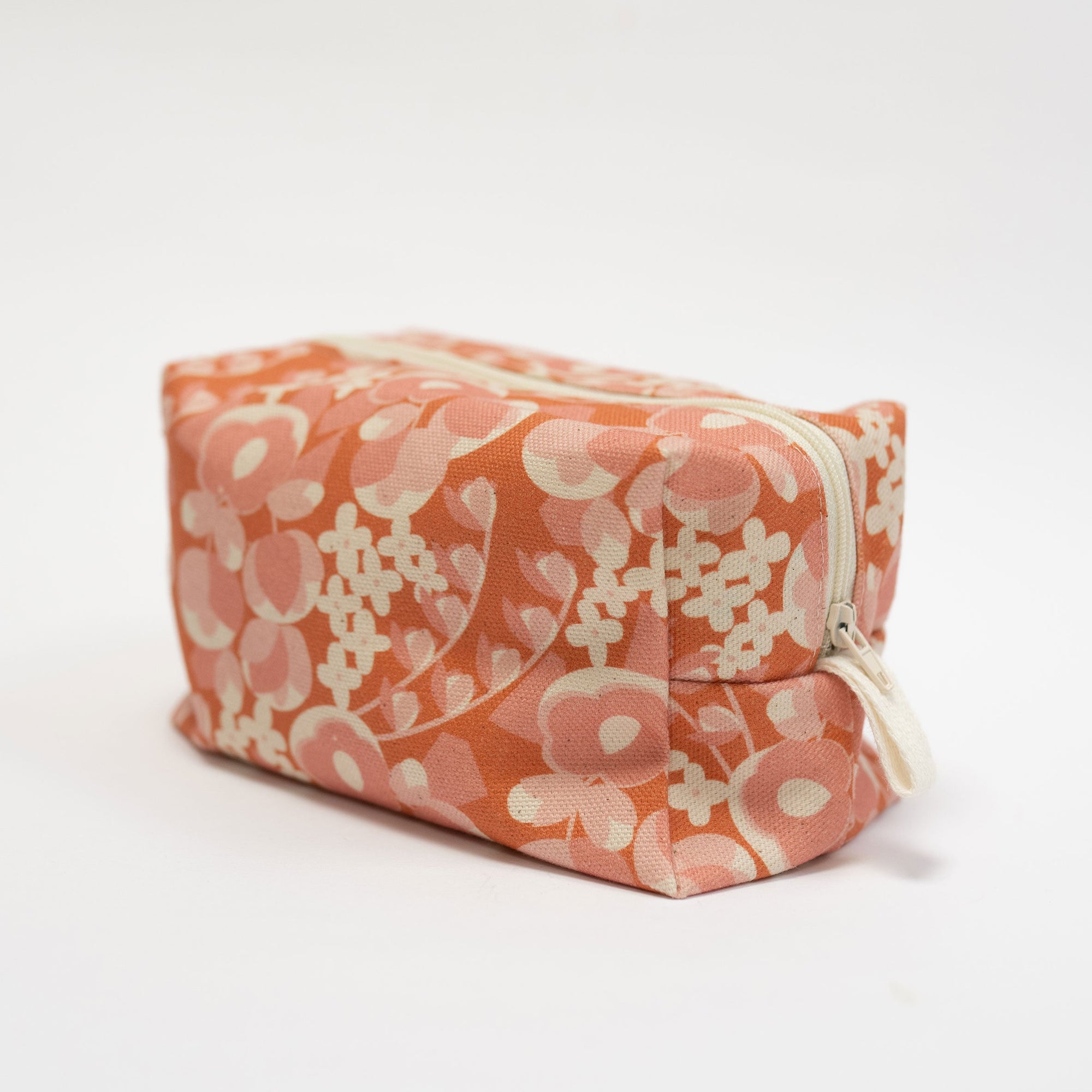 Floral-patterned makeup bag on a white background