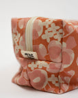 Floral-patterned fabric pouch with a zipper on a white background