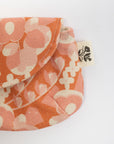 Floral-patterned pouch with a visible brand tag on a white background