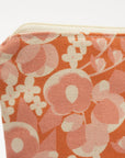 Floral patterned pouch with a visible brand tag on a white background