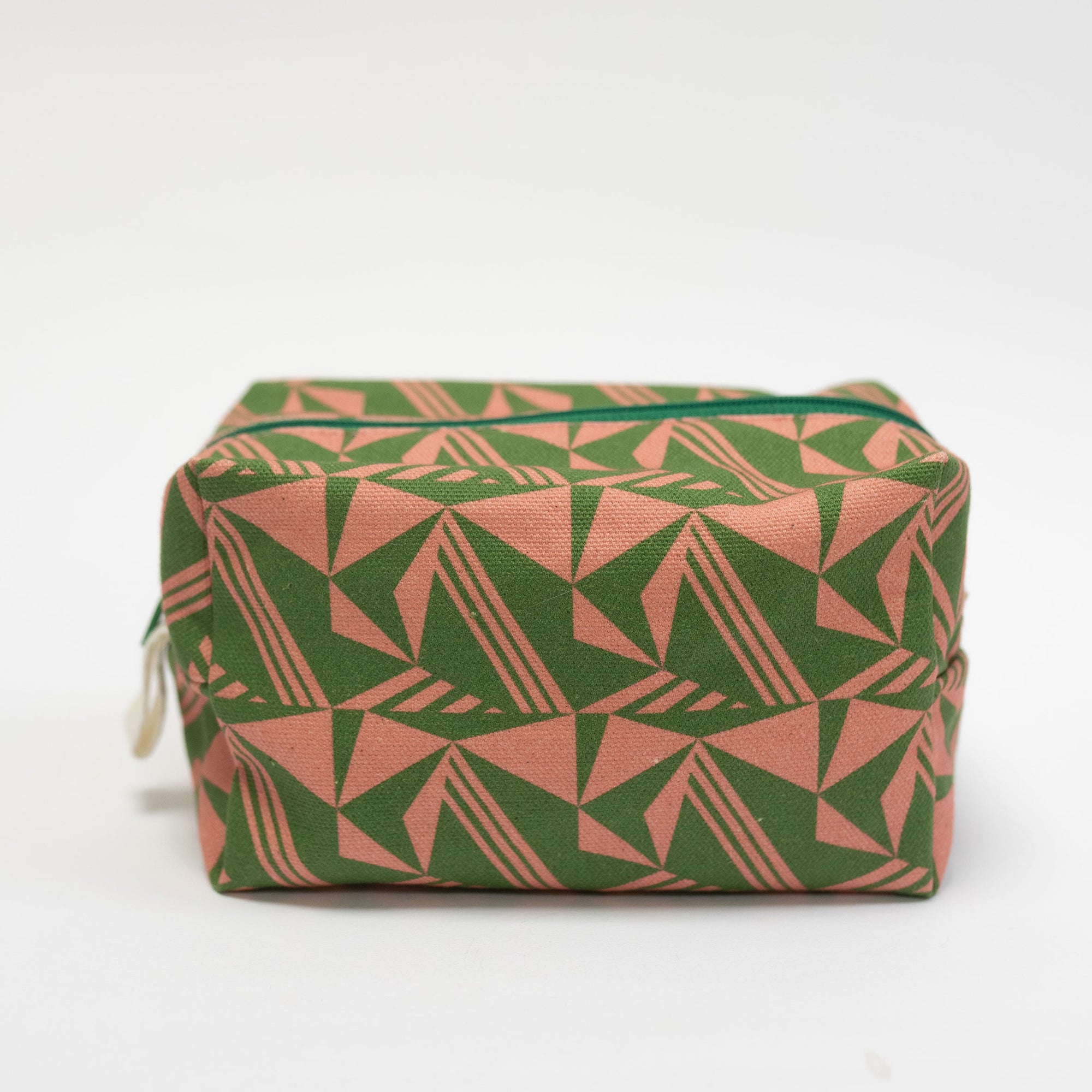 Green and pink geometric patterned pouch on a white background