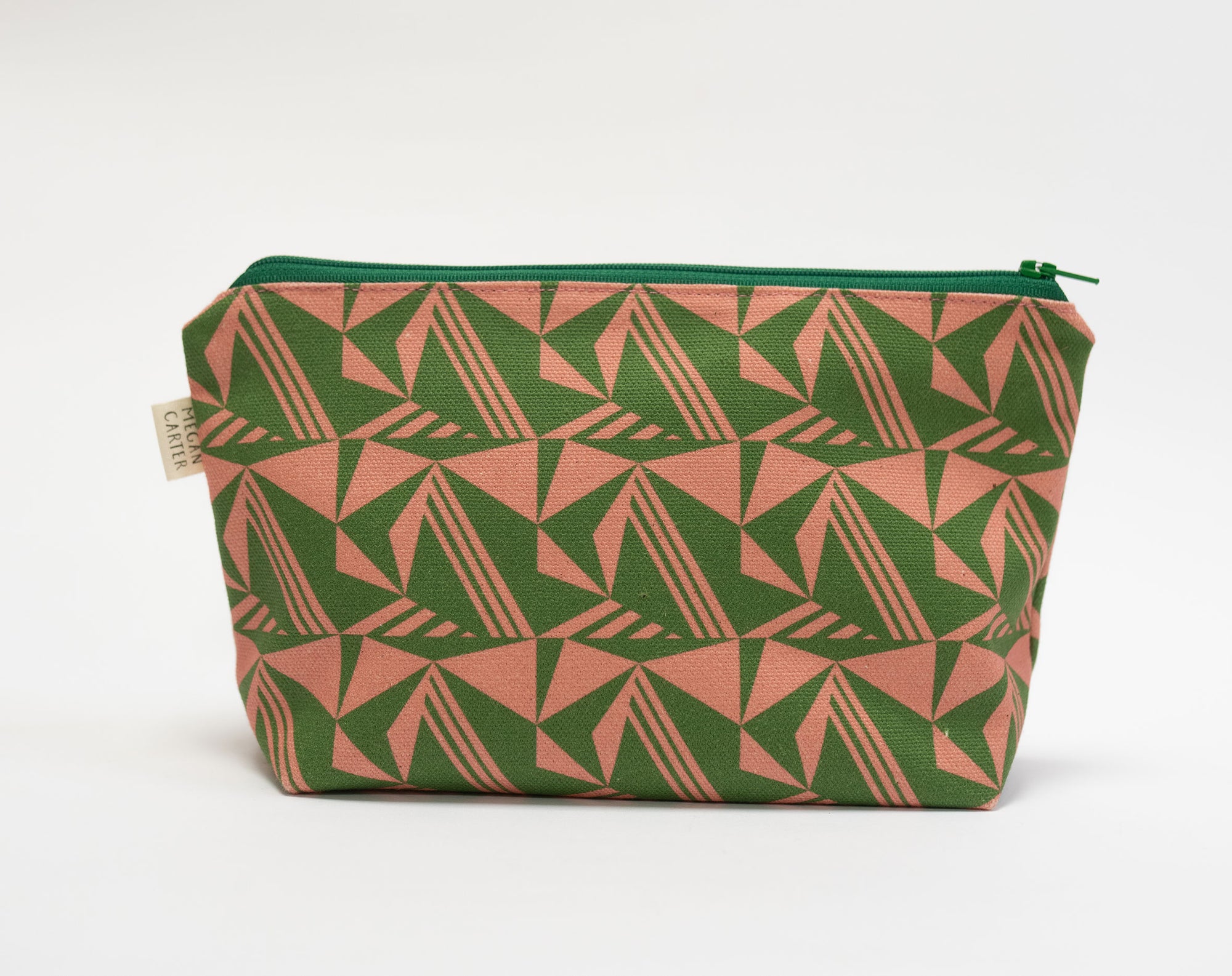 Green and pink geometric patterned pouch on a white background