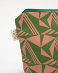 Green and pink geometric patterned pouch with a visible brand label on a white background