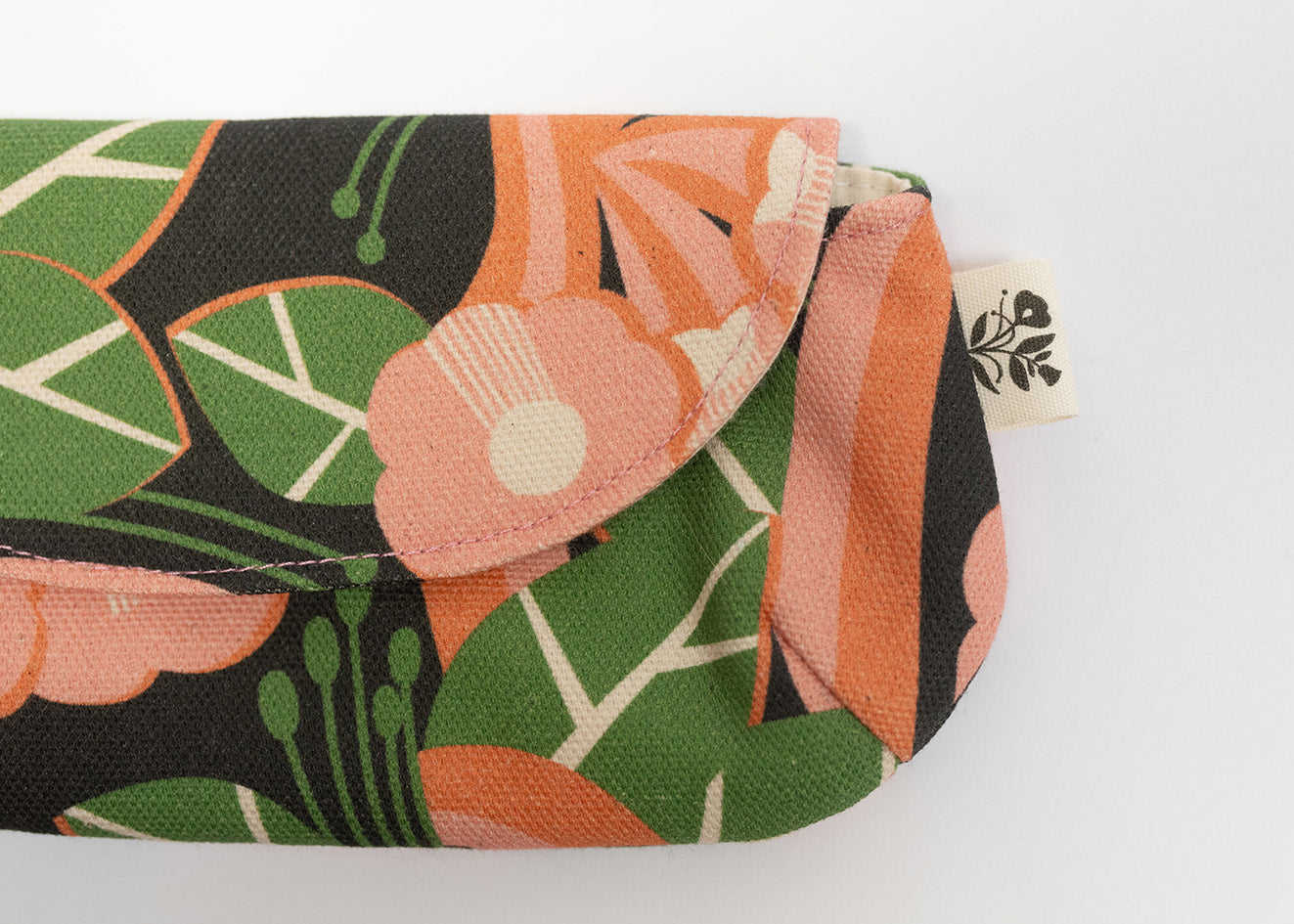 Floral patterned pouch with green leaves and orange flowers on a white background