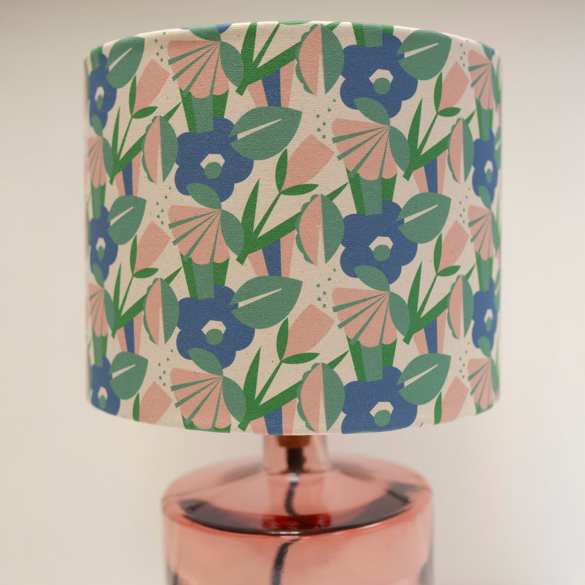A 30cm drum lampshade with a digitally printed pattern featuring organic cotton flowers in various shades of blue and green, displayed on a lamp post.